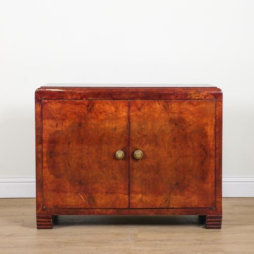 AN ART DECO FIGURED WALNUT TWO DOOR SIDE CABINET