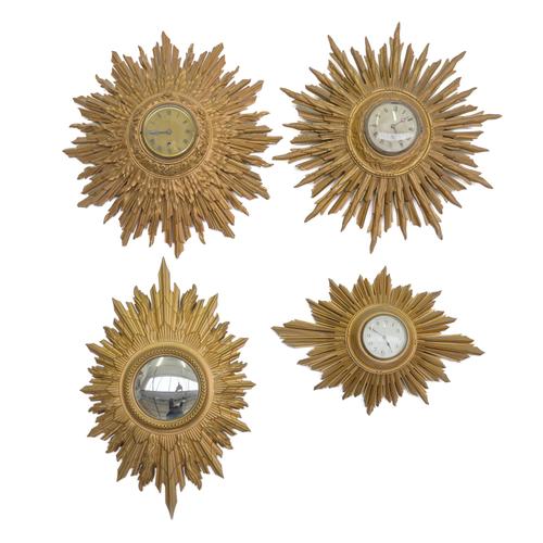 A GROUP OF THREE GILT-WOOD  ‘SUNBURST’ WALL TIMEPIECES AND A WALL MIRROR (4)