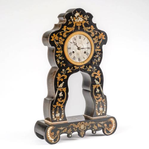 A NAPOLEON III EBONISED, CUT-BRASS AND IVORY-INLAID MANTEL CLOCK