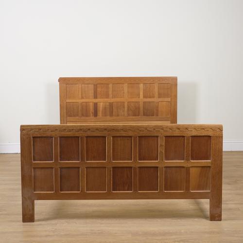 ROBERT MOUSEMAN THOMPSON; A 20TH CENTURY PANELLED OAK BED