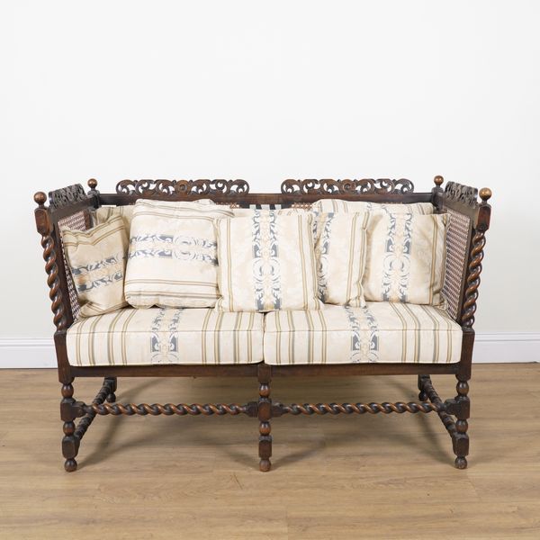 AN EARLY 20TH CENTURY STAINED BEECH FRAMED CANE SOFA