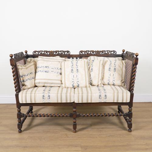 AN EARLY 20TH CENTURY STAINED BEECH FRAMED CANE SOFA