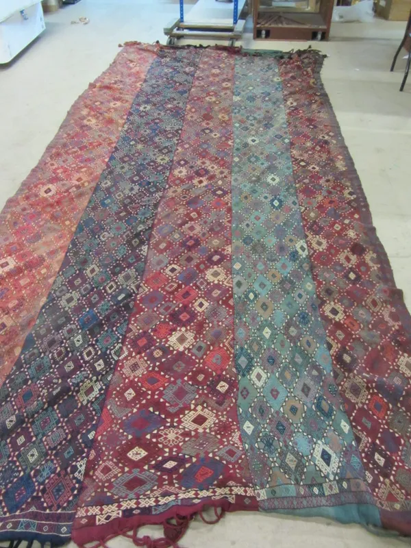 A Turkman flatweave carpet in fine strips, all with embroidered diamond design, 430cm x 182cm.