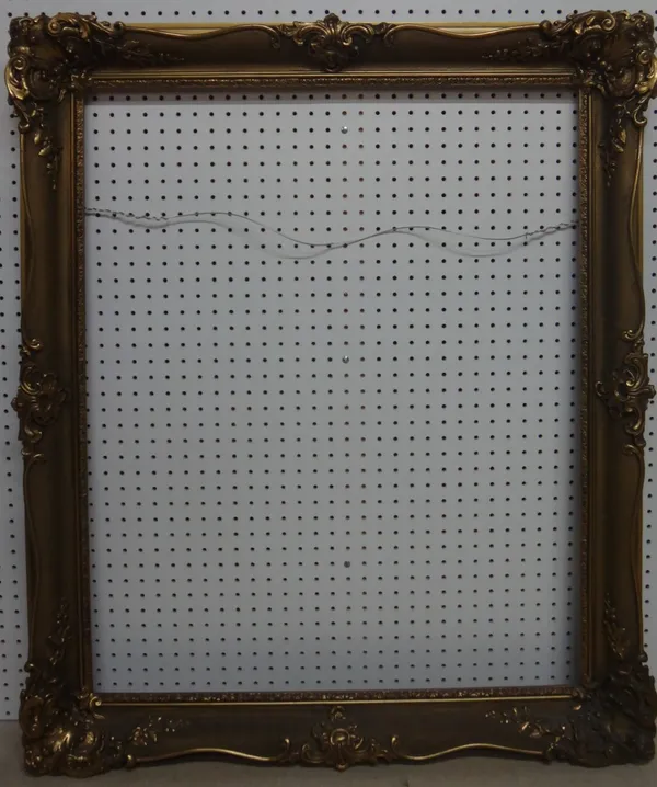 A 20th century gilt plaster swept frame, the aperture 95cm x 76.5cm.