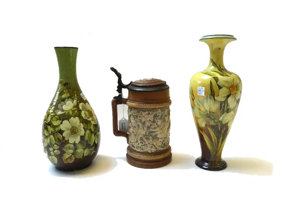 A Mettlach stoneware flagon with pewter mounted lid, 21cm high, and two Doulton faience vases with floral decoration (a.f). (3)