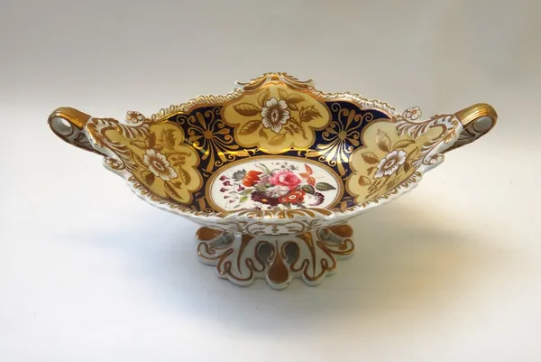 A Ridgway porcelain part dessert service, circa 1825, painted with a central flower group against a blue ground reserved with deep cream and gilt flow