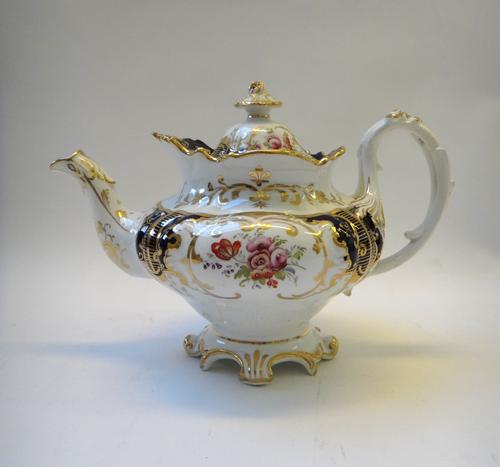 A group of Ridgway porcelain teawares, 19th century, comprising; a `Union' pattern teapot and cover and milk jug, painted with roses and thistles, thr