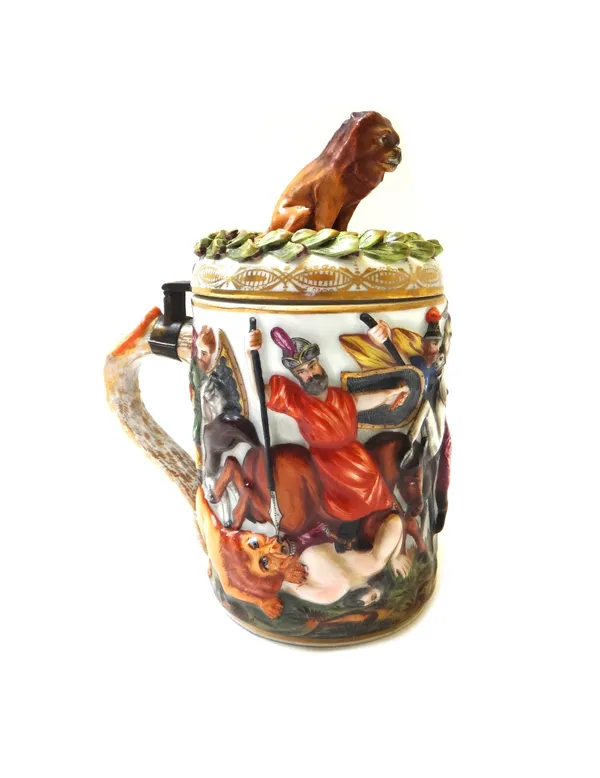 A Herend porcelain lidded tankard, early 20th century, relief moulded with a classical battle scene, with a lion finial, gold mark to base (a.f), 20cm