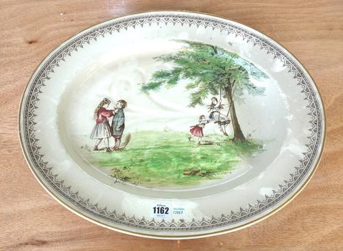 A Doulton Burslem pottery meat drainer, late 19th century, decorated with children on a swing, 50cm wide, together with a matching oval meat platter,