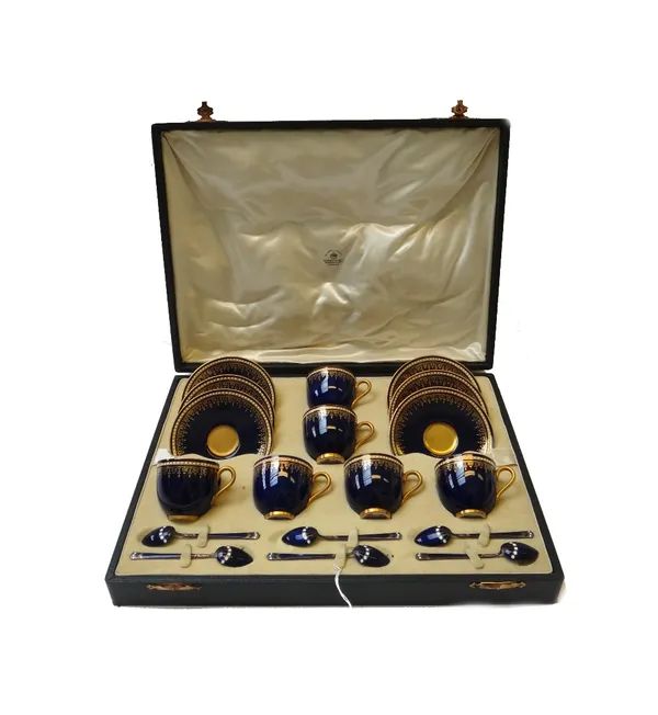 A Royal Worcester six piece coffee service, circa 1930, with gilt foliate decoration against a cobalt blue ground and jewelled rim, comprising; six co