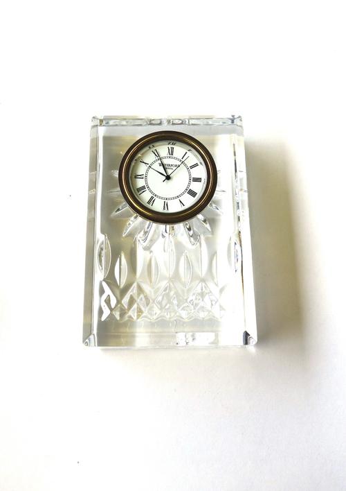 A matched part suite of crystal, comprising; a decanter and stopper, six tumblers, six smaller tumblers, a clock and a comport. (15)