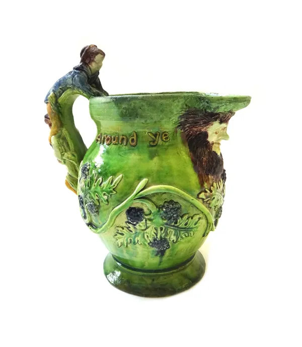 A Castle Hedingham pottery jug with figural handle, titled 'Mulberry bush', 23cm high.
