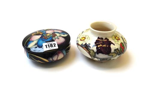 A Moorcroft 'Sandringham Bouquet' vase of squat form, dated 2007, 8cm high, and a Moorcroft 'Night Time Serenade' pot and cover, dated 2007, 12cm diam