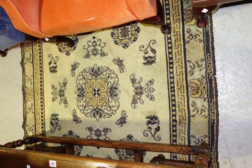 A 20th century red ground  Bokhara style rug, a Chinese style yellow rug and a blue and red prayer mat (3)