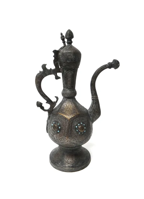 An Ottoman engraved bronze ewer, 19th century, on a conical foot, the panelled pear shaped body with a row of raised bosses encircled by turquoise blu