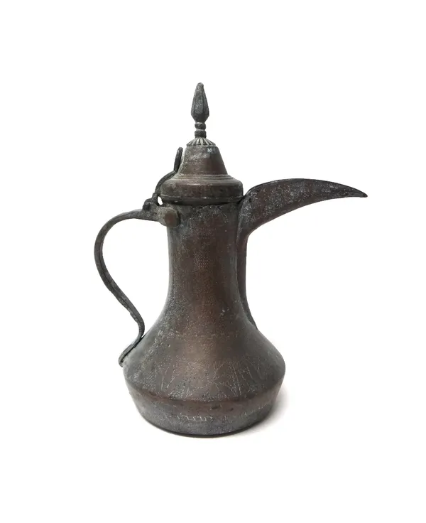 An Ottoman engraved copper ewer, 19th century, the squat body engraved with flower panels beneath a waisted neck, hinged cover and curved spout, 35cm.