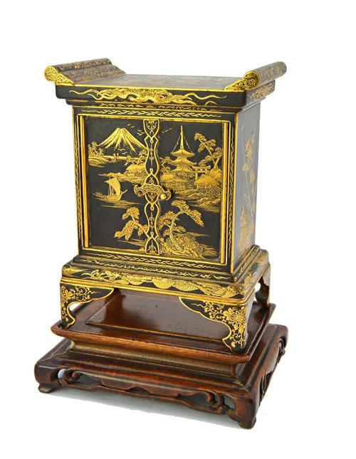 A Japanese Komai-style inlaid brass rectangular miniature cabinet, 20th century, the pair of hinged doors opening to reveal five drawers, applied thro