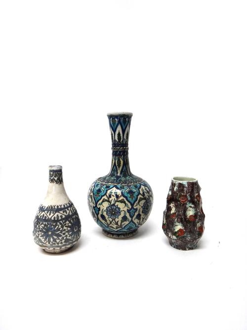 An Iznik style bottle vase, 19th century, painted in typical palette with barbed panels enclosing flowers and leaves (a.f), 31cm. high; also an Islami