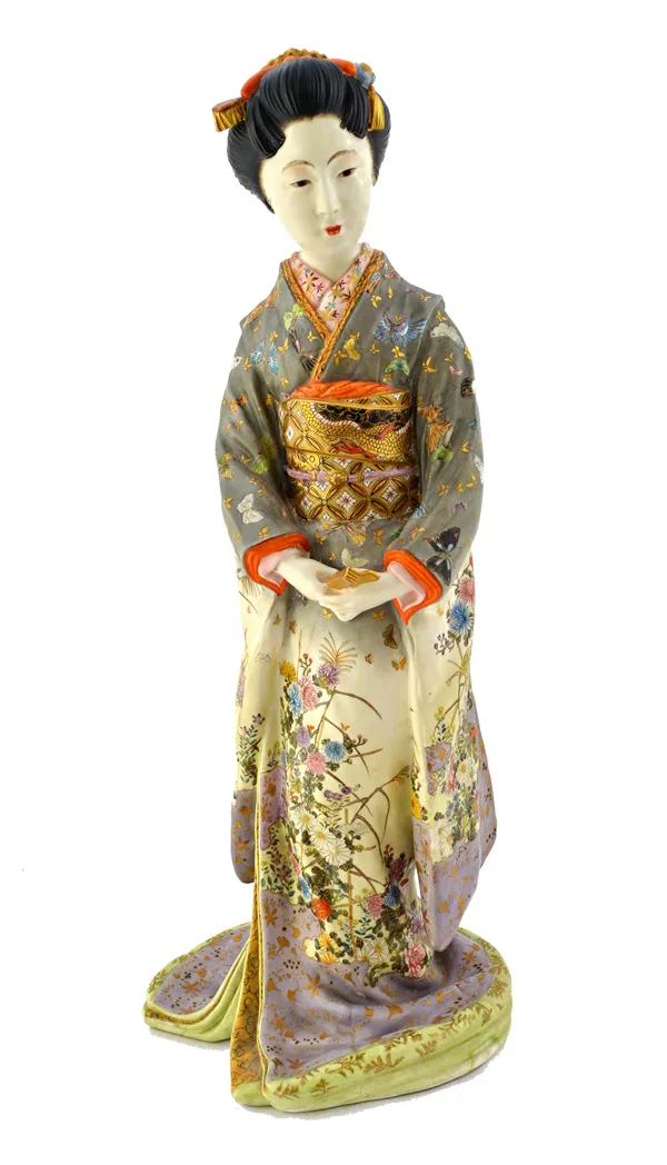 A good Japanese Satsuma figure of a young woman by Kinkozan, Meiji period, standing holding a fan, wearing a kimono painted with insects and flowering