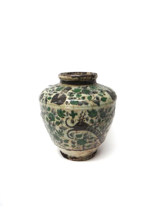 A Qajar earthenware vase, 19th century, of ovoid form, painted around the body with equestrian figures and beasts, the shoulders painted with  four he