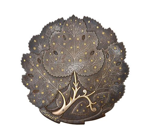 A damascened leaf shaped dish, probably North India, 19th century, formed as overlapping leaves, the centre inlaid with a mongoose holding a snake in