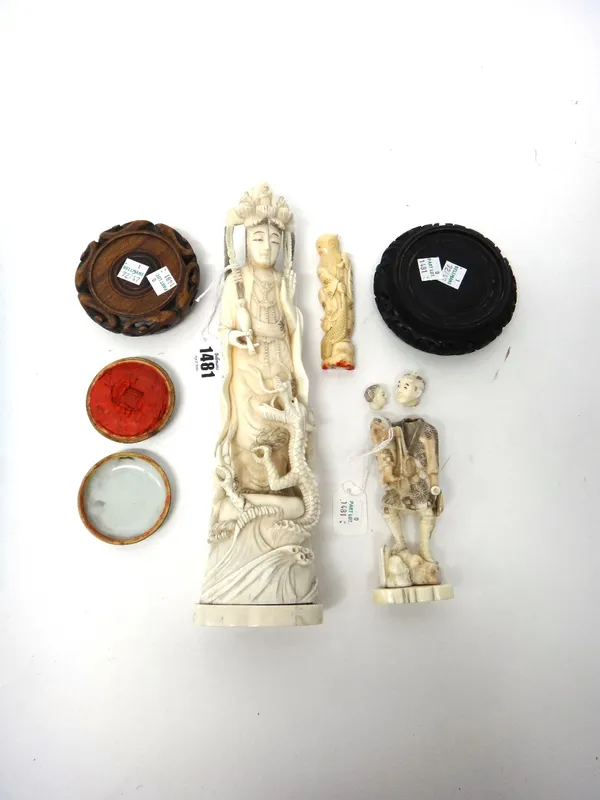 A group of three ivory carvings, early 20th century, comprising; a Chinese ivory carving of Guanyin with a dragon at her feet, 31cm. high, a Japanese