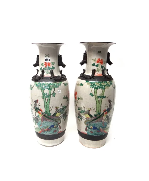 A pair of Chinese crackleware baluster vases, 20th century, each painted in a famille verte palette with birds amongst flowering shrubs, 60cm. high. (