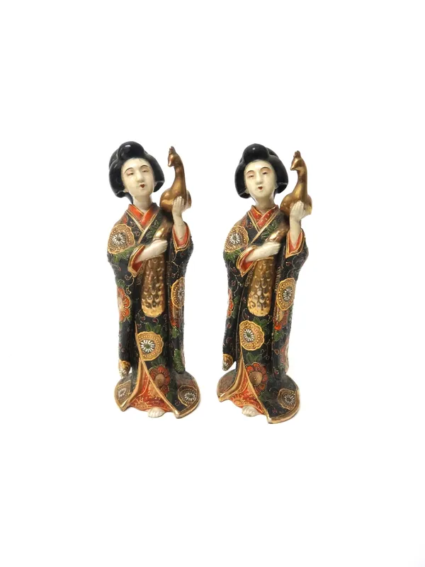 Two similar Japanese Satsuma figures of bijin, 20th century, each standing wearing a kimono and supporting a gilt peacock in one hand (one a.f), 31cm.