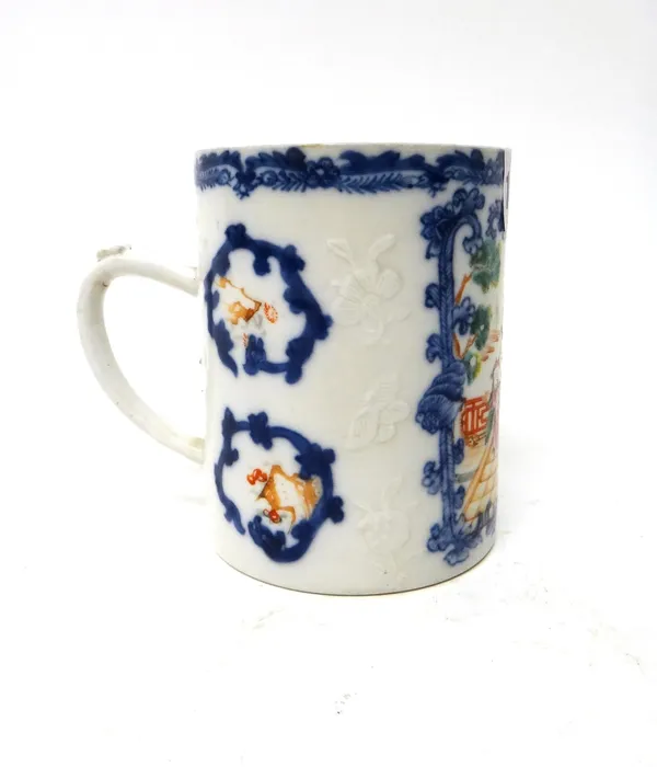 A Chinese export famille-rose cylindrical mug, Qianlong, painted with a figurative panel inside an underglaze blue foliate border, 11.5cm. high