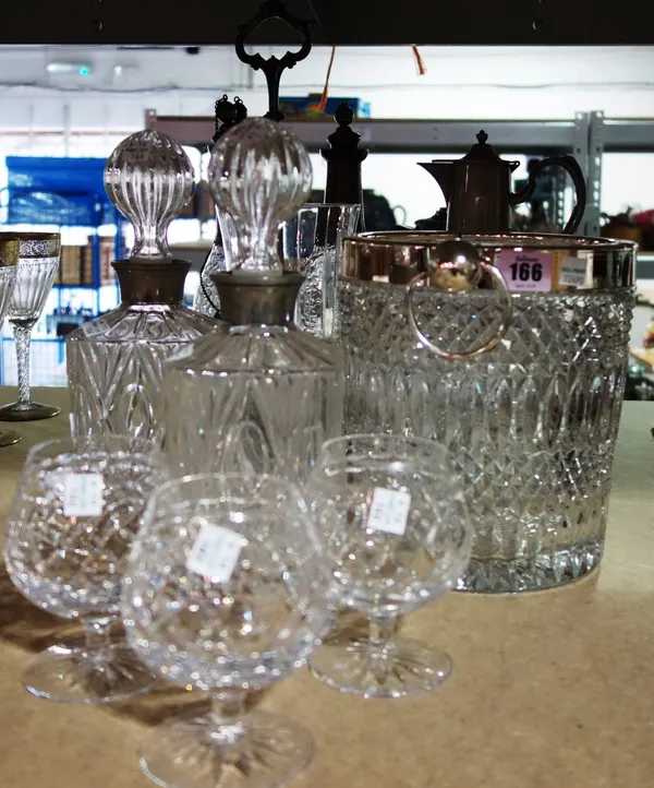 A quantity of cut glass to include decanters, an ice bucket, claret jugs, an Elkington and Co silver plated three bottle decanter stand and sundry. (q