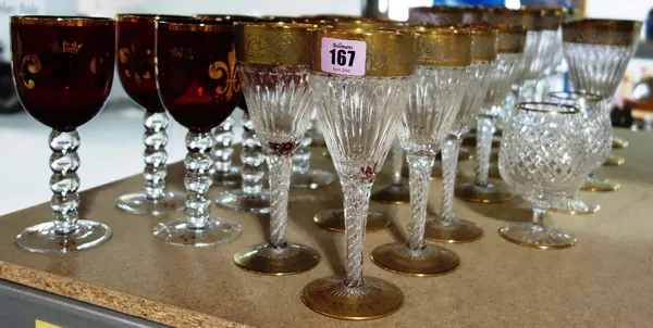 A part suite of gilt decorated cut glass dining glasses and a part suite of ruby glasses. (qty)