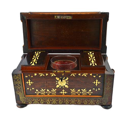 A Regency brass and bone inlaid rosewood rectangular tea caddy, with twin lidded interior on bun feet, 34cm wide.  Illustrated