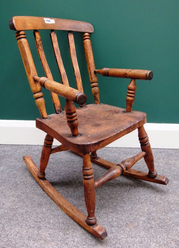 A 19th century child's ash and elm rocking chair, with turned supports, 67cm high.