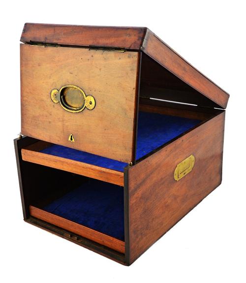 An 18th century Campaign design travelling box, with lift top and front pivoting panel, enclosing two pull-out trays, 30cm wide.  Illustrated