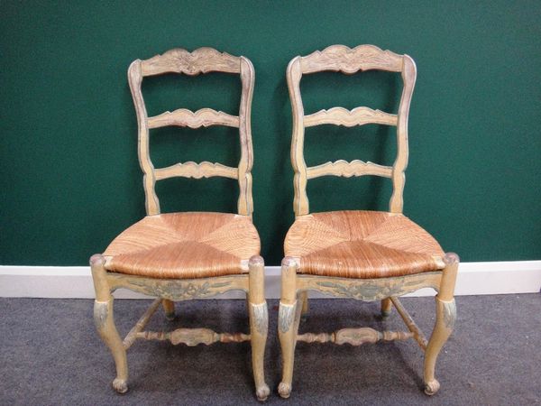 A set of ten French 19th century yellow and blue painted dining chairs with shell carved crest and rush seat on cabriole supports.