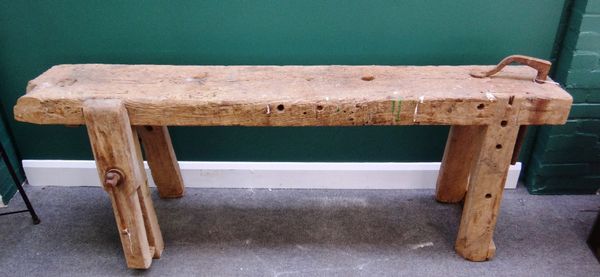 An oak framed rectangular work bench, with integral leg vice and moveable wrought iron bracket, 189cm wide.