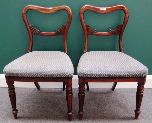 A set of four mid-19th century rosewood kidney back dining chairs on lappet carved supports.