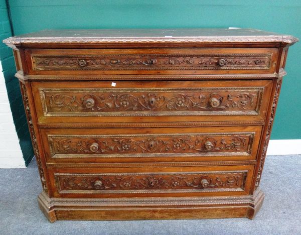 A 19th century Italian carved walnut commode, of four long graduated drawers, flanked by canted corners on plinth base, 147cm wide,