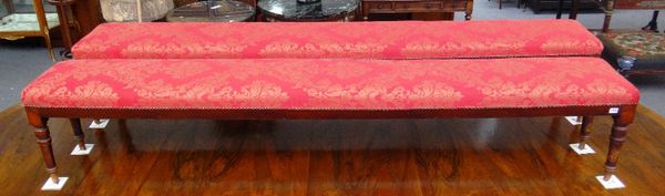 A pair of large mahogany framed rectangular footstools on tapering turned supports, 247cm wide.