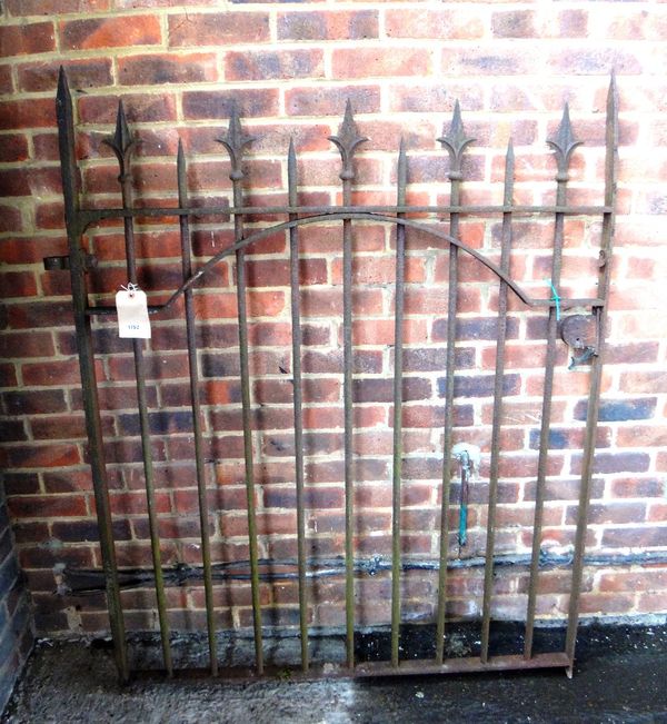 A mid-Victorian wrought iron gate with fleur de lys finials, 124cm wide and 160cm high.