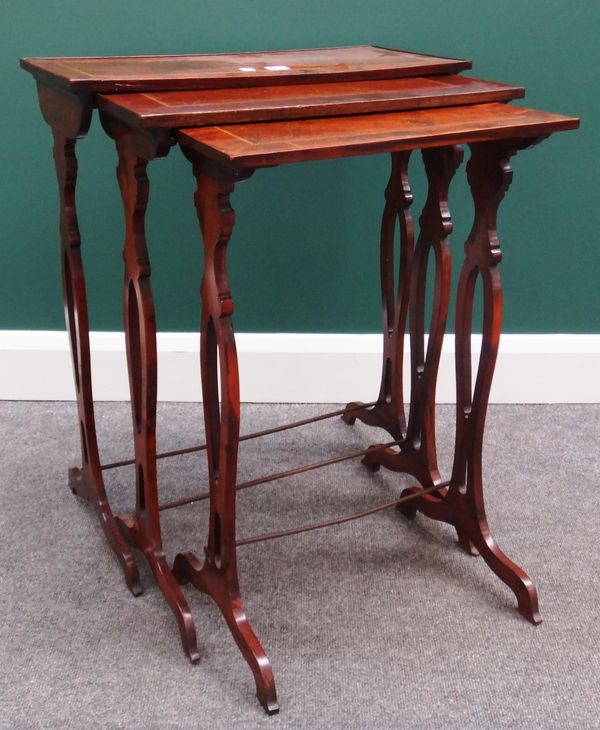 A nest of three 19th century yew wood rectangular occasional tables, on pierced silhouette supports, the largest 60cm wide.