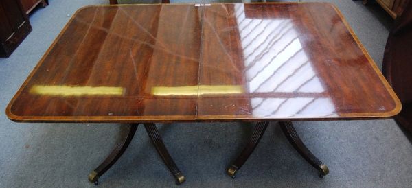 A Regency style mahogany 'D' end extending dining table, the crossbanded top on eight downswept supports, to include two extra leaves, 112cm wide x 17