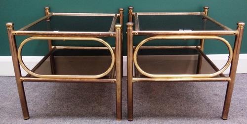 A pair of 20th century tubular brass and smoked glass square two tier occasional tables, 50cm wide.
