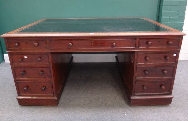 A Victorian mahogany partners pedestal desk with nine drawers about the knee, the opposing with three frieze drawers over pair of cupboards on plinth