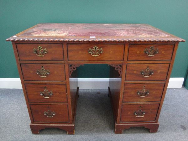 A late 19th century mahogany writing desk, the gadrooned top over nine drawers on bracket feet, 107cm wide.