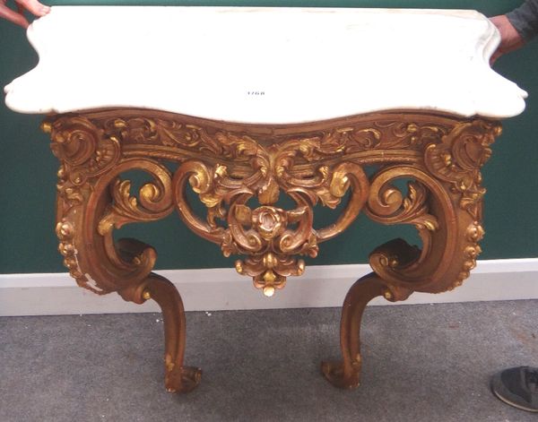 A 19th century console table, the serpentine marble top over a gilt base with carved and pierced acanthus scroll frieze, raised on two opposing C-scro