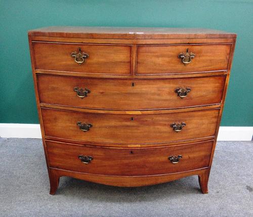 An early 19th century mahogany bow front chest of two short and three long graduated drawers on splayed bracket feet, 105cm wide.
