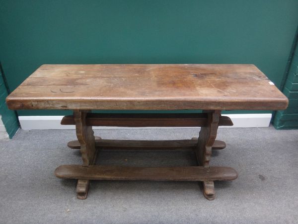 A 17th century style oak refectory table, the single slab rectangular top on shaped trestle end standards, 51cm wide x 151cm long x 7cm thick.