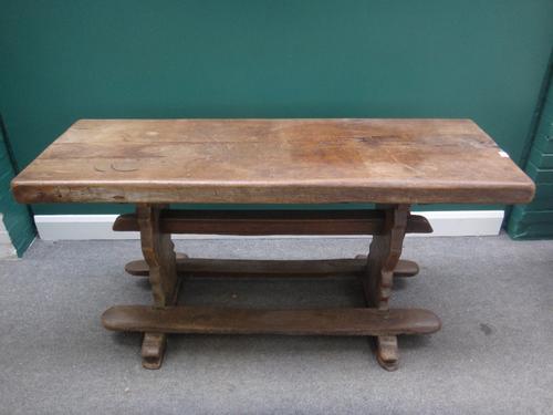 A 17th century style oak refectory table, the single slab rectangular top on shaped trestle end standards, 51cm wide x 151cm long x 7cm thick.