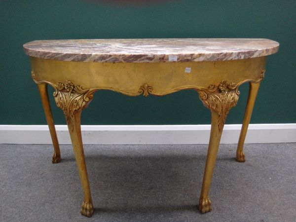 An 18th century style demi-lune console, the marble top over a gilt base with shaped frieze and four slender cabriole supports on lions paw feet, 123c